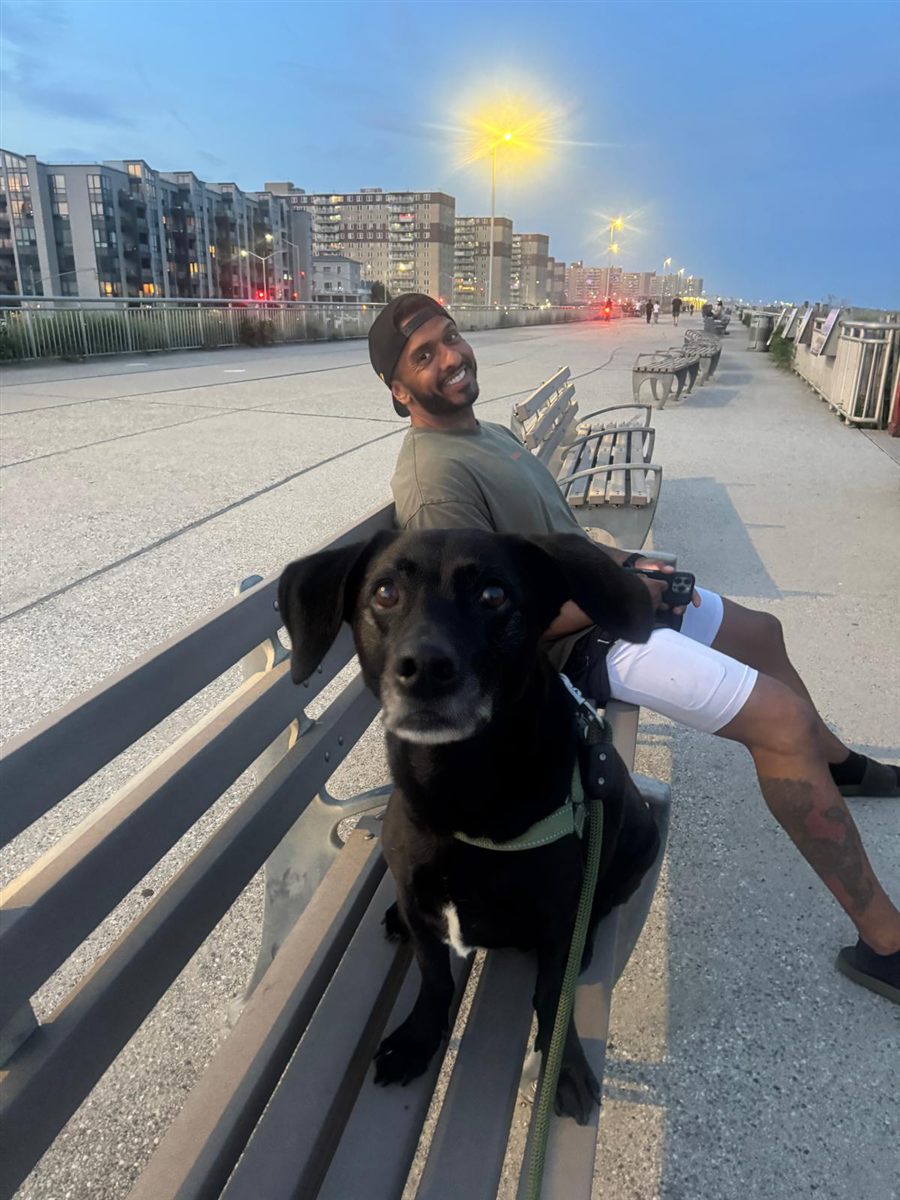 Jay with his dog on the Rockaway boardwalk at dusk